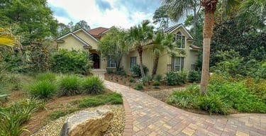 a house with a brick walkway and a stone path