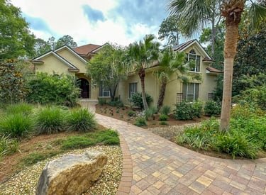 a house with a brick walkway and a stone path