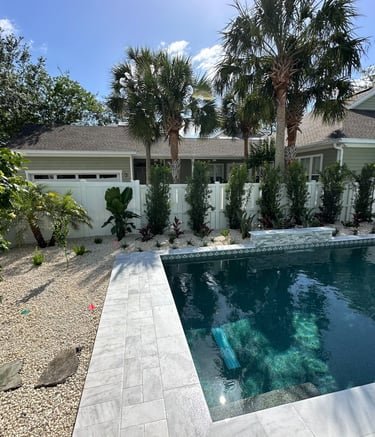 a pool with a pool and a house in the background