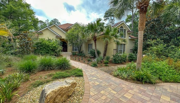 a house with a brick walkway and a stone path